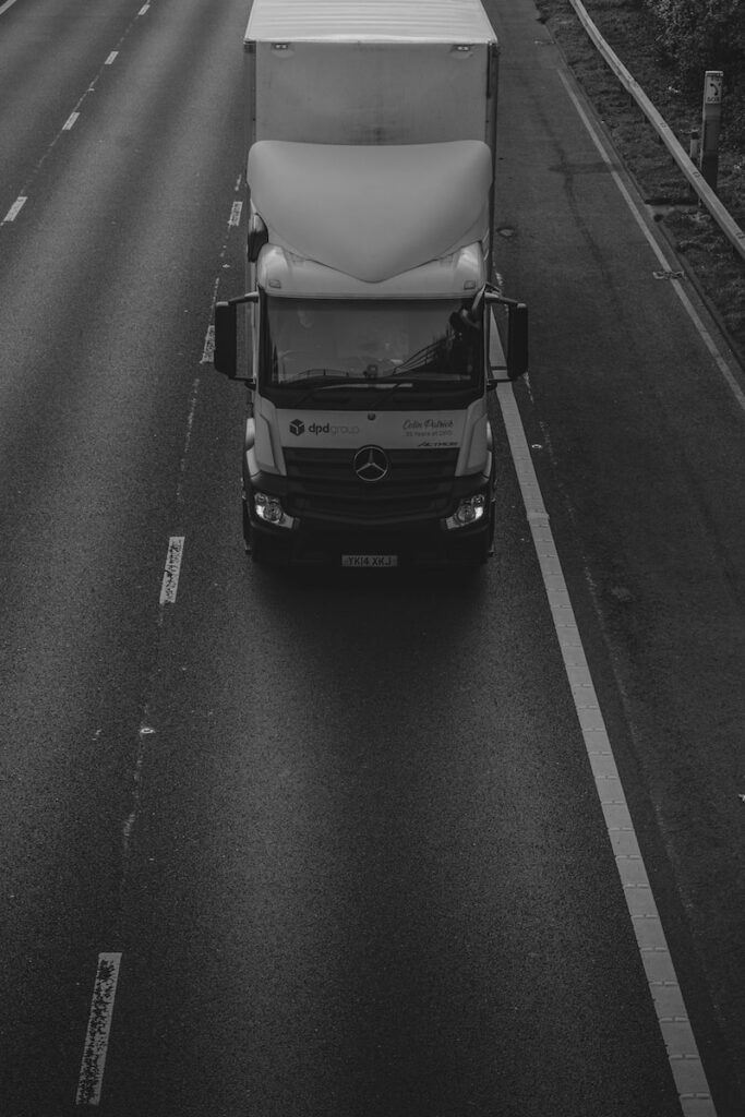 grayscale photo of car on road